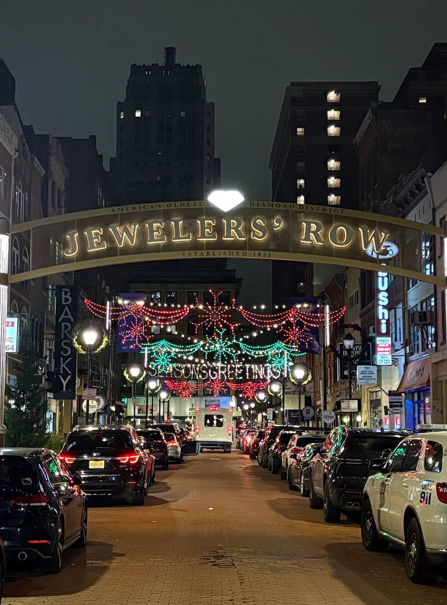 Nighttime view of a busy urban street named 