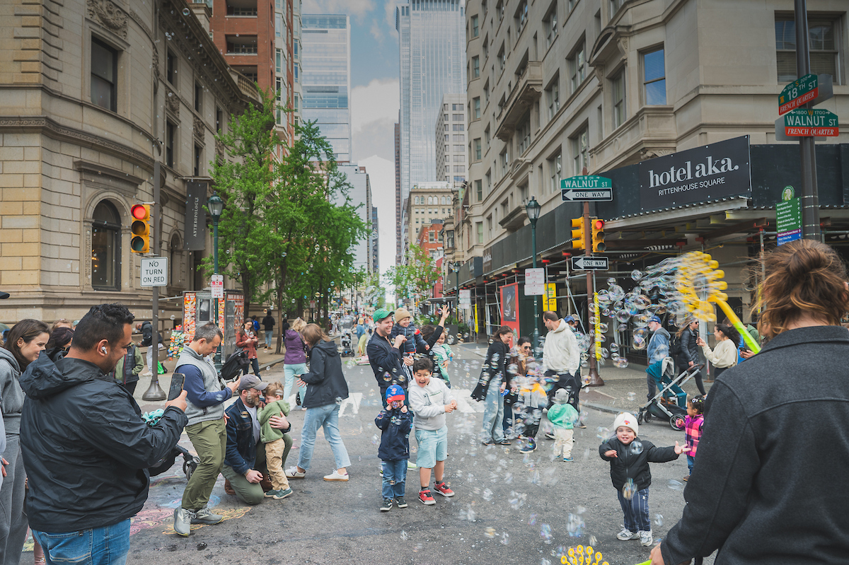 Children enjoying bubble entertainment with their parents.