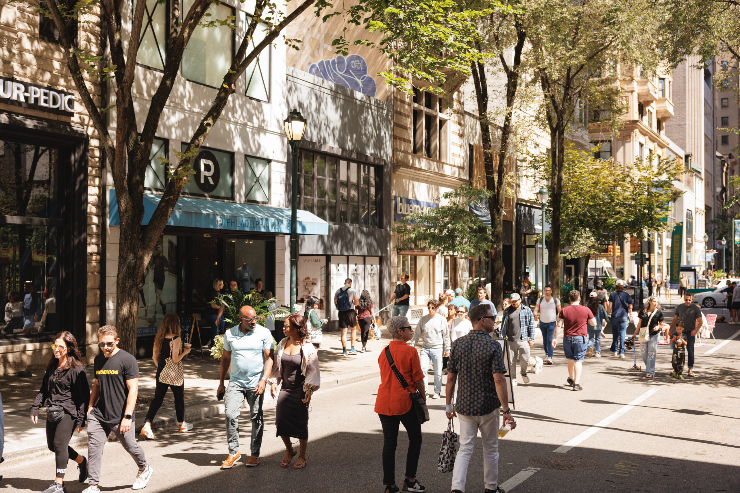 people walking on walnut street during open streets in philadelphia.